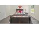 Inviting bedroom features a well-made bed, side table, and rustic star decor at 404 Saddlebred Ln, Locust, NC 28097