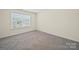 Clean bedroom features a well-lit window at 404 Saddlebred Ln, Locust, NC 28097