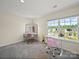 Bright bedroom with makeup vanity, a large window, and desk for work, creating a comfortable space at 404 Saddlebred Ln, Locust, NC 28097