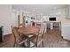 Eat-in kitchen with a rustic table and chairs, connecting to the rest of the living area at 404 Saddlebred Ln, Locust, NC 28097