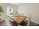 Cozy dining room with wood floors, bright window, and table with rustic wood chairs at 404 Saddlebred Ln, Locust, NC 28097