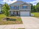 Charming two-story home featuring stone accents, a two-car garage, and a well-manicured lawn at 404 Saddlebred Ln, Locust, NC 28097