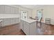Bright eat-in kitchen featuring an island, a stainless steel refrigerator, and wood floors at 404 Saddlebred Ln, Locust, NC 28097