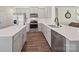Bright kitchen featuring white countertops and cabinets, stainless steel appliances, and hardwood floors at 404 Saddlebred Ln, Locust, NC 28097