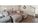 Open concept living room featuring a neutral palette, staircase, and wood floors at 404 Saddlebred Ln, Locust, NC 28097