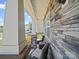 Inviting porch features stacked stone accents, comfortable seating, and charming architectural details for relaxation at 404 Saddlebred Ln, Locust, NC 28097