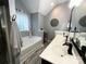 Bathroom showcasing a soaking tub with gray wood-look tile flooring and double vanity at 4205 Springhaven Dr, Charlotte, NC 28269
