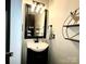 Updated bathroom with vanity, modern fixtures, mirror, and decor at 4205 Springhaven Dr, Charlotte, NC 28269