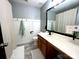 Clean bathroom with large mirror, white and wood paneling, and modern fixtures at 4205 Springhaven Dr, Charlotte, NC 28269