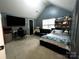Upstairs bedroom with bed, sofa, mounted TV and desk area at 4205 Springhaven Dr, Charlotte, NC 28269