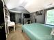 Upstairs bedroom with bed, mounted TV and desk area with decorative touches at 4205 Springhaven Dr, Charlotte, NC 28269