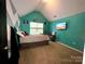 Bright teal bedroom with bed, mounted TV, window, and vaulted ceiling at 4205 Springhaven Dr, Charlotte, NC 28269