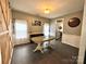 Dining room featuring tile floors, a sliding barn door, and view to kitchen at 4205 Springhaven Dr, Charlotte, NC 28269