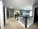 Upstairs landing with neutral colors, white spindles, and view into kitchen area at 4205 Springhaven Dr, Charlotte, NC 28269