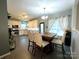 Eat-in kitchen features white cabinets, stainless steel appliances, and a large dining table with chairs at 4205 Springhaven Dr, Charlotte, NC 28269