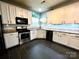 Updated kitchen features stainless steel appliances, granite countertops, and subway tile backsplash at 4205 Springhaven Dr, Charlotte, NC 28269