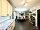 Open concept kitchen features white cabinets, stainless steel appliances, and opens to the living room at 4205 Springhaven Dr, Charlotte, NC 28269