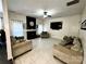 Bright living room with a fireplace, large TV, stylish decor and tile flooring at 4205 Springhaven Dr, Charlotte, NC 28269