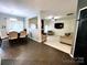 Open-concept living spaces combining dining area, living room with fireplace, and modern tile floors at 4205 Springhaven Dr, Charlotte, NC 28269