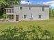 Spacious backyard featuring a white brick home with an enclosed porch and patio at 4615 Lockhart Rd, Sharon, SC 29742