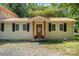 This home features a front entryway with a wooden front door, neutral siding, and black shutters at 4919 Rehobeth Rd, Waxhaw, NC 28173