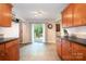 Kitchen features light wood cabinetry, tile flooring, and sliding glass doors to the deck at 4919 Rehobeth Rd, Waxhaw, NC 28173
