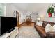 Open-concept living and dining areas with hardwood floors, a leather sofa, and natural light at 4919 Rehobeth Rd, Waxhaw, NC 28173