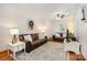 Inviting living room featuring two sofas, hardwood floors, and natural light from the windows at 4919 Rehobeth Rd, Waxhaw, NC 28173