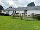 Expansive backyard featuring a wooden deck and lush greenery, perfect for outdoor entertaining at 5816 Scotland Yard Rd, Rock Hill, SC 29732