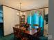 Elegant dining room featuring a wooden table, chandelier, and decorative curtains at 5816 Scotland Yard Rd, Rock Hill, SC 29732