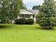 Inviting home featuring a cozy covered front porch and mature landscaping at 5816 Scotland Yard Rd, Rock Hill, SC 29732