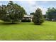 Charming single-story home with a well-manicured front yard and mature trees at 5816 Scotland Yard Rd, Rock Hill, SC 29732