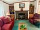 Cozy living room featuring a stone fireplace, built-in bookshelves, and comfortable seating at 5816 Scotland Yard Rd, Rock Hill, SC 29732