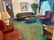 Cozy living room showcasing a sofa, armchair, wood tables, green carpet and bright, natural light at 5816 Scotland Yard Rd, Rock Hill, SC 29732