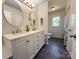 Bright bathroom featuring a double sink vanity with quartz countertops and brushed nickel faucets at 608 E 11Th St, Newton, NC 28658