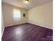 This is a bedroom with light walls, a window and dark wood flooring at 608 E 11Th St, Newton, NC 28658
