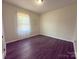 Cozy bedroom with natural light, dark wood flooring, and neutral wall colors at 608 E 11Th St, Newton, NC 28658