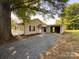 View of house with gravel driveway and detached two car carport at 608 E 11Th St, Newton, NC 28658