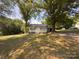 Charming home featuring a quaint porch, complemented by fresh, neutral siding, and a durable metal roof at 608 E 11Th St, Newton, NC 28658