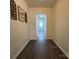 Long hallway with decor on the left wall and a light wall color at 608 E 11Th St, Newton, NC 28658