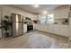 Modern kitchen with stainless steel appliances, white cabinetry, light countertops and tile floors at 608 E 11Th St, Newton, NC 28658