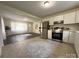 Bright open concept kitchen and living space featuring tile and hardwood flooring at 608 E 11Th St, Newton, NC 28658