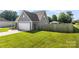 Fenced backyard features green grass and access to a two car garage at 6401 Morehead Rd, Harrisburg, NC 28075