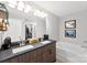 Modern bathroom featuring a double vanity, soaking tub, and stylish fixtures, providing a luxurious feel at 6401 Morehead Rd, Harrisburg, NC 28075