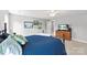 Bright bedroom featuring a patterned duvet, television, and a hallway view, providing a relaxing atmosphere at 6401 Morehead Rd, Harrisburg, NC 28075