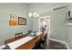 Dining room with a long wooden table and view to the kitchen at 6401 Morehead Rd, Harrisburg, NC 28075