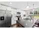 Modern kitchen featuring white cabinets, stainless steel appliances, and a large island at 6401 Morehead Rd, Harrisburg, NC 28075