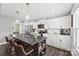 Modern kitchen featuring white cabinets, stainless steel appliances, and a large island at 6401 Morehead Rd, Harrisburg, NC 28075