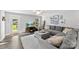 Spacious living room with a comfortable gray sectional sofa and natural light at 6401 Morehead Rd, Harrisburg, NC 28075