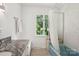 Bright bathroom with white cabinets, granite countertop, modern fixtures, and shower at 7107 Cedarfield Rd, Charlotte, NC 28227
